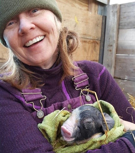 Dr. Laurie Thorp holding a pig. 